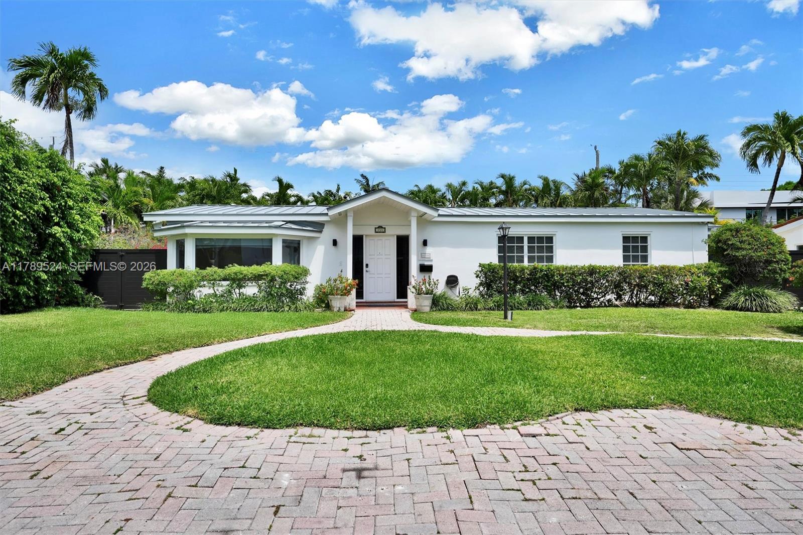 255 Ridgewood Road Key Biscayne, FL 33149 - Photo 3 of 61 a view of house with a yard