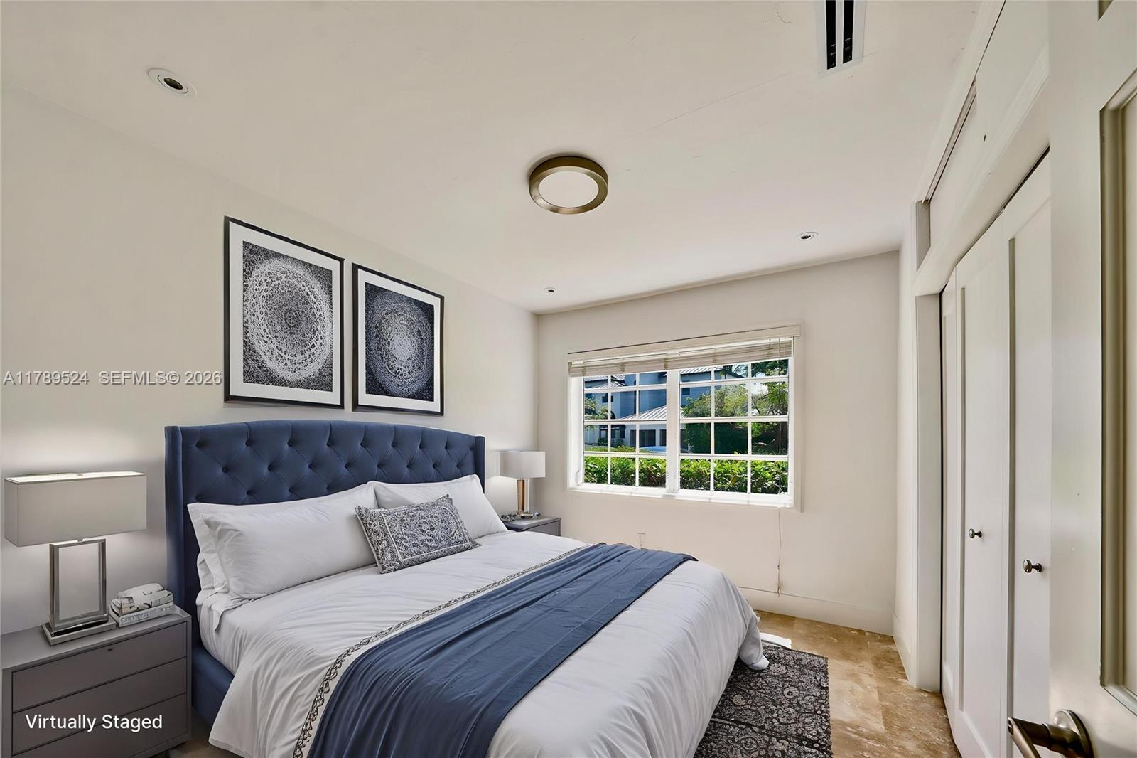 255 Ridgewood Road Key Biscayne, FL 33149 - Photo 32 of 61 a bedroom with a large bed and a window