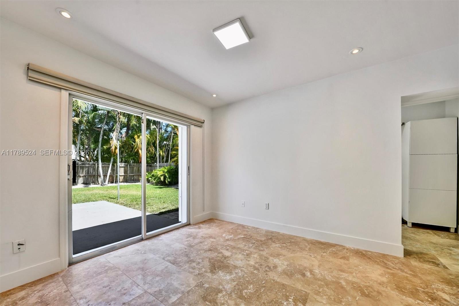 255 Ridgewood Road Key Biscayne, FL 33149 - Photo 41 of 61 a view of an empty room with wooden floor and a window