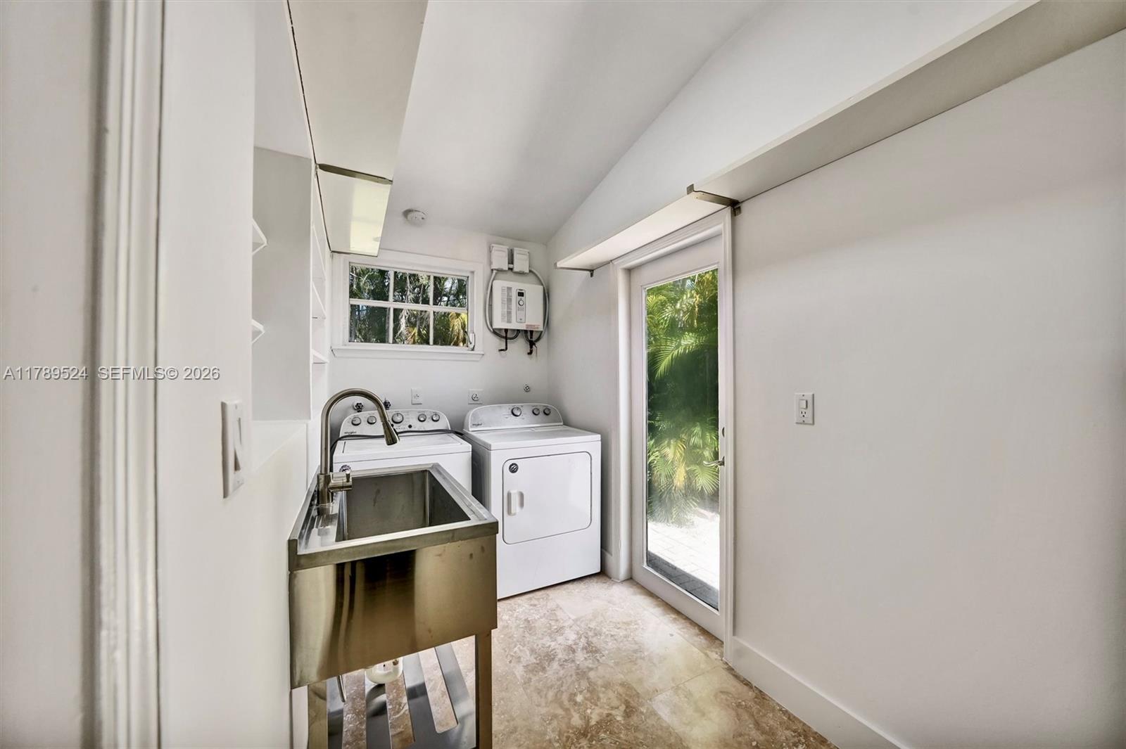 255 Ridgewood Road Key Biscayne, FL 33149 - Photo 47 of 61 a kitchen with a refrigerator and a sink