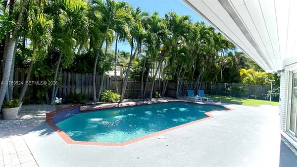 a view of a house with backyard porch and sitting area