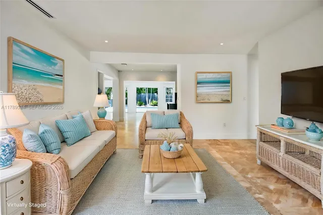 a view of a hallway with wooden floor and a living room