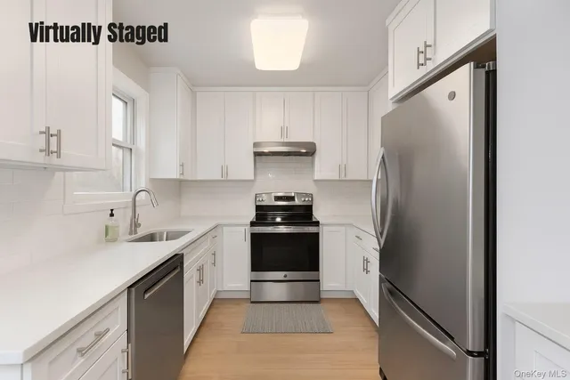a kitchen with a refrigerator and a sink