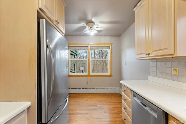 a kitchen with granite countertop cabinets a sink and appliances