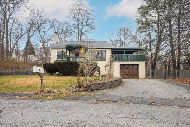 a front view of a house with a yard covered with snow in front of house