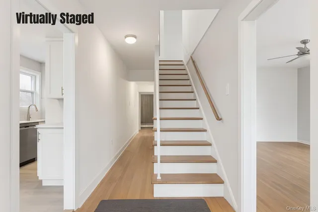 a view of a hallway with wooden floor and entryway