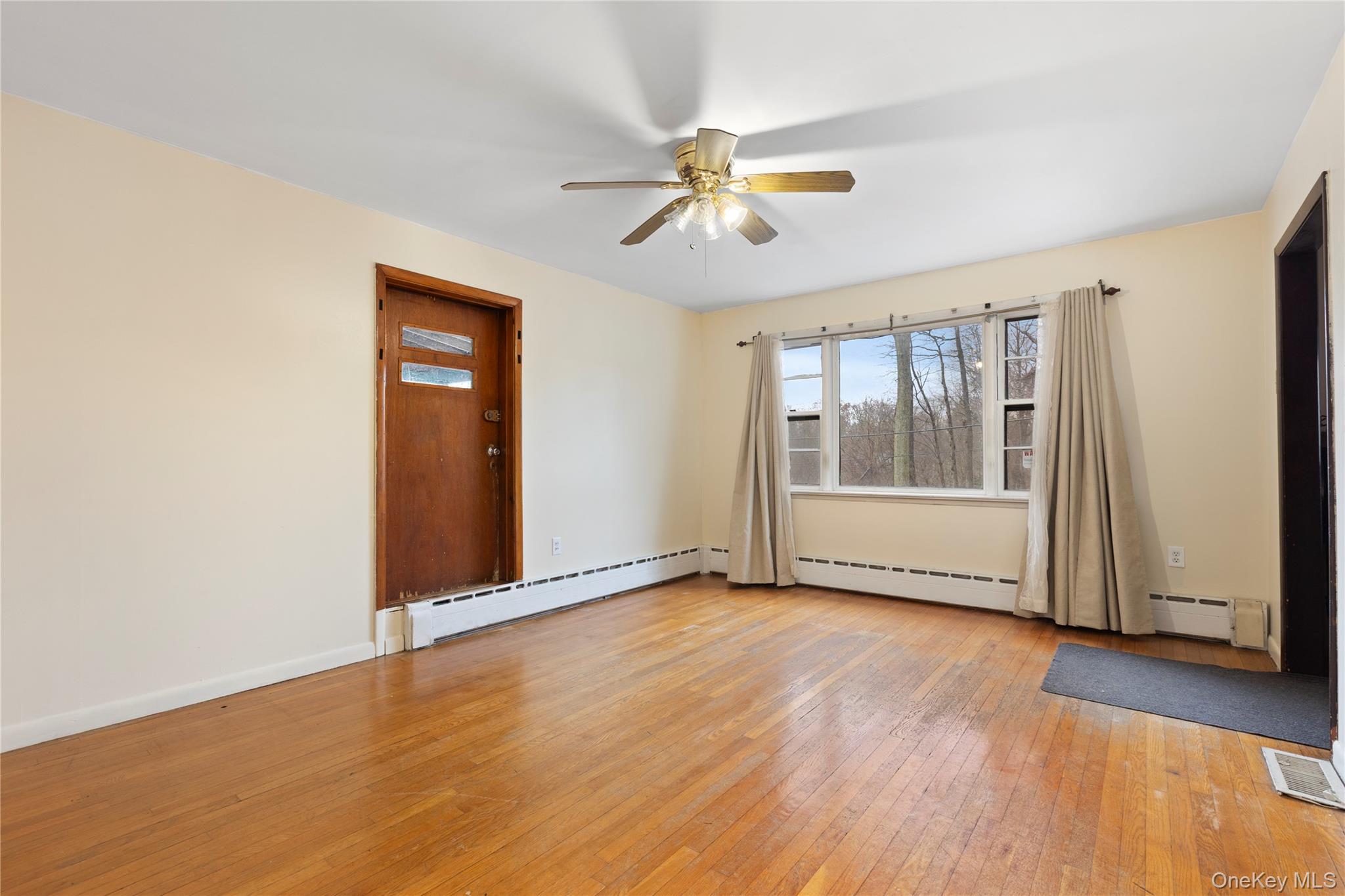 7 Venice Road Patterson, NY 12563 - Photo 6 of 35 a view of an empty room with wooden floor and a window