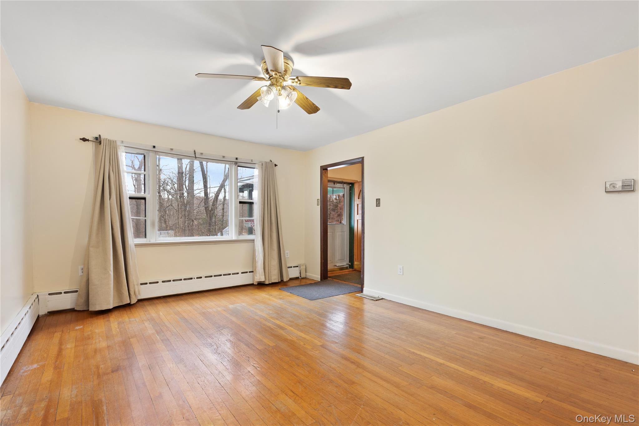7 Venice Road Patterson, NY 12563 - Photo 8 of 35 a view of an empty room with a window and wooden floor