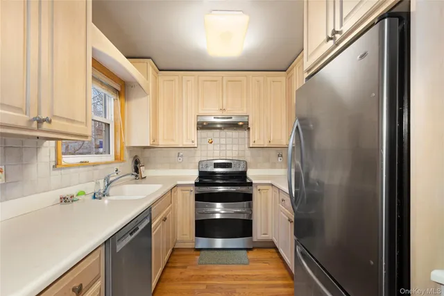 a kitchen with a sink stove and refrigerator