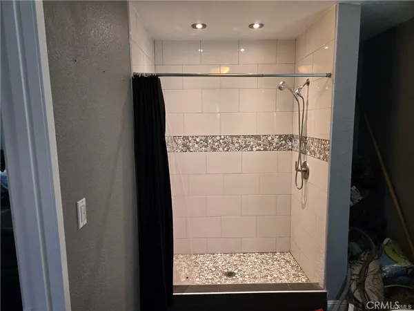 a bathroom with a glass shower door