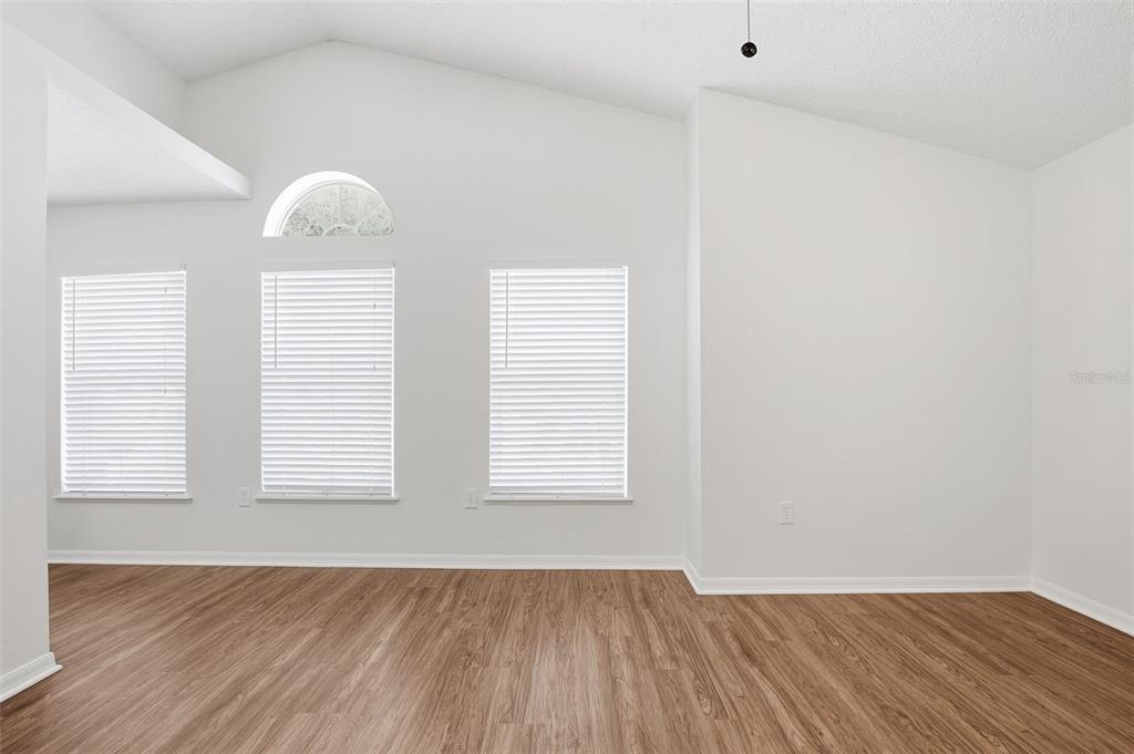 11331 Ivy Flower Loop Riverview, FL 33578 - Photo 15 of 36 an empty room with wooden floor and windows