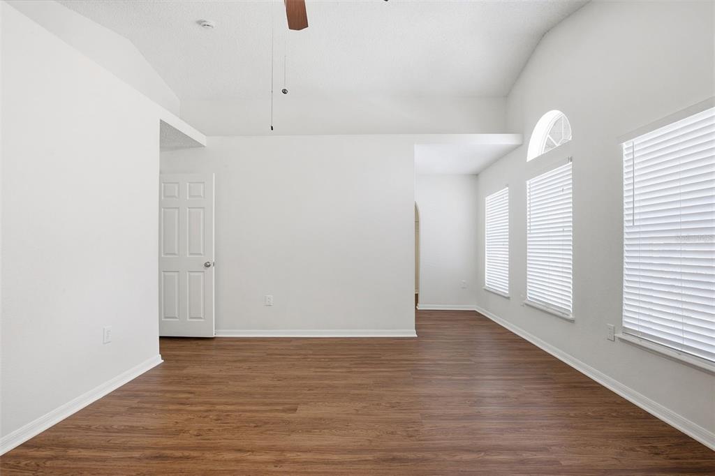11331 Ivy Flower Loop Riverview, FL 33578 - Photo 16 of 36 a view of an empty room with wooden floor and a window