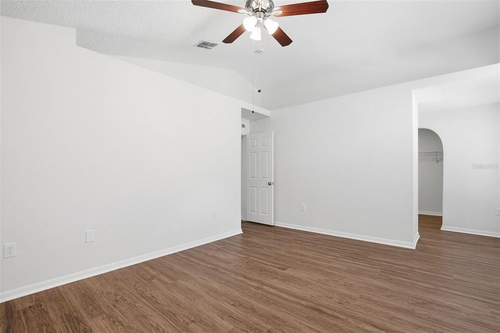 11331 Ivy Flower Loop Riverview, FL 33578 - Photo 17 of 36 a view of an empty room with wooden floor