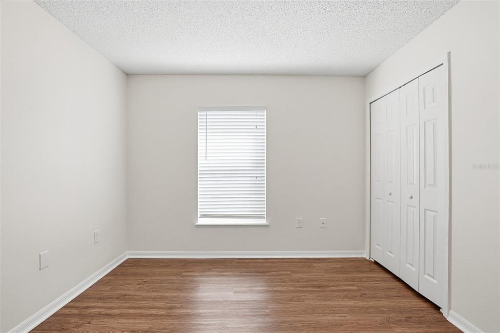 11331 Ivy Flower Loop Riverview, FL 33578 - Photo 19 of 36 an empty room with wooden floor and windows