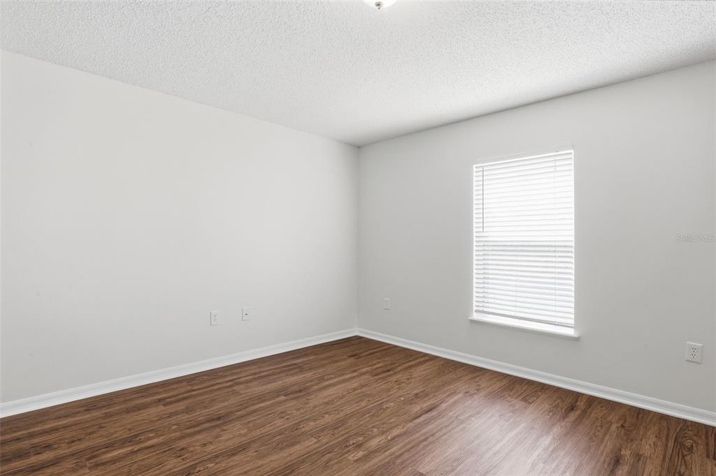 11331 Ivy Flower Loop Riverview, FL 33578 - Photo 22 of 36 an empty room with wooden floor and windows