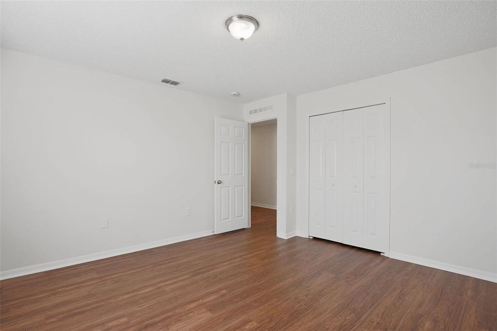 11331 Ivy Flower Loop Riverview, FL 33578 - Photo 24 of 36 a view of an empty room with wooden floor