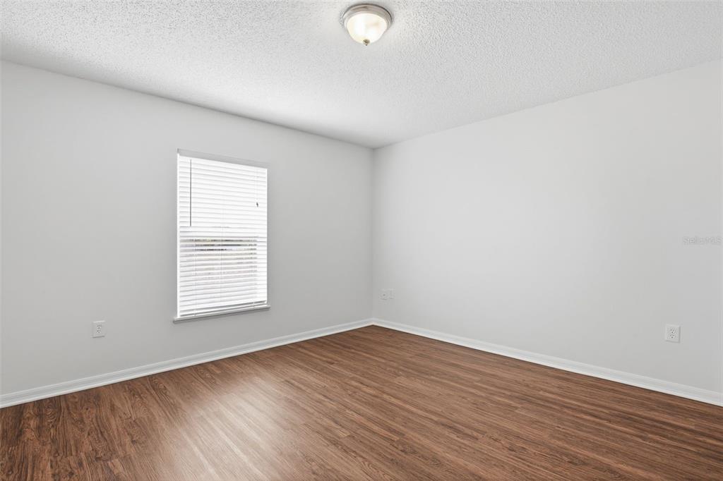11331 Ivy Flower Loop Riverview, FL 33578 - Photo 25 of 36 an empty room with wooden floor and windows