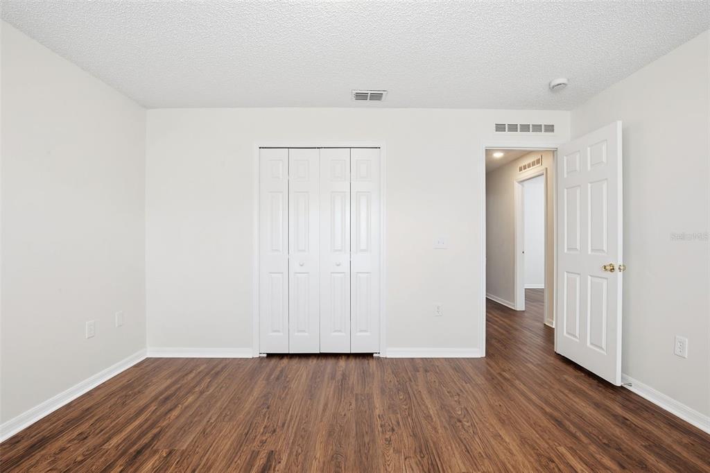 11331 Ivy Flower Loop Riverview, FL 33578 - Photo 26 of 36 a view of an empty room with wooden floor and closet