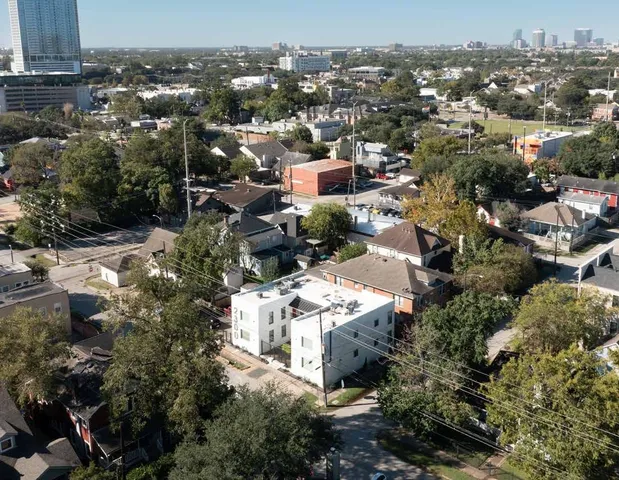 an aerial view of residential houses with city view