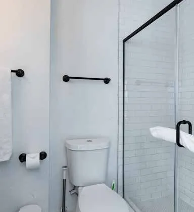 a bathroom with a toilet and a shower