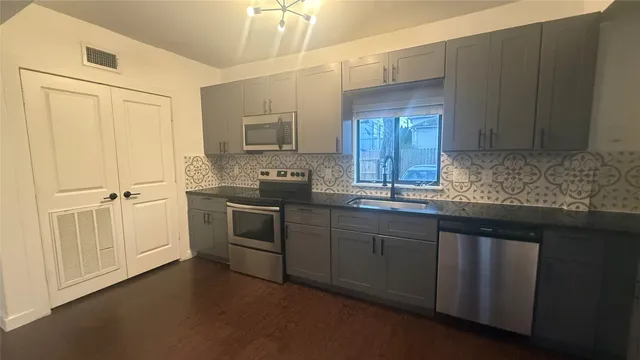 a kitchen with a sink cabinets and window