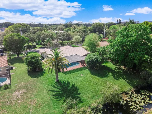 a view of a garden with a building in the background