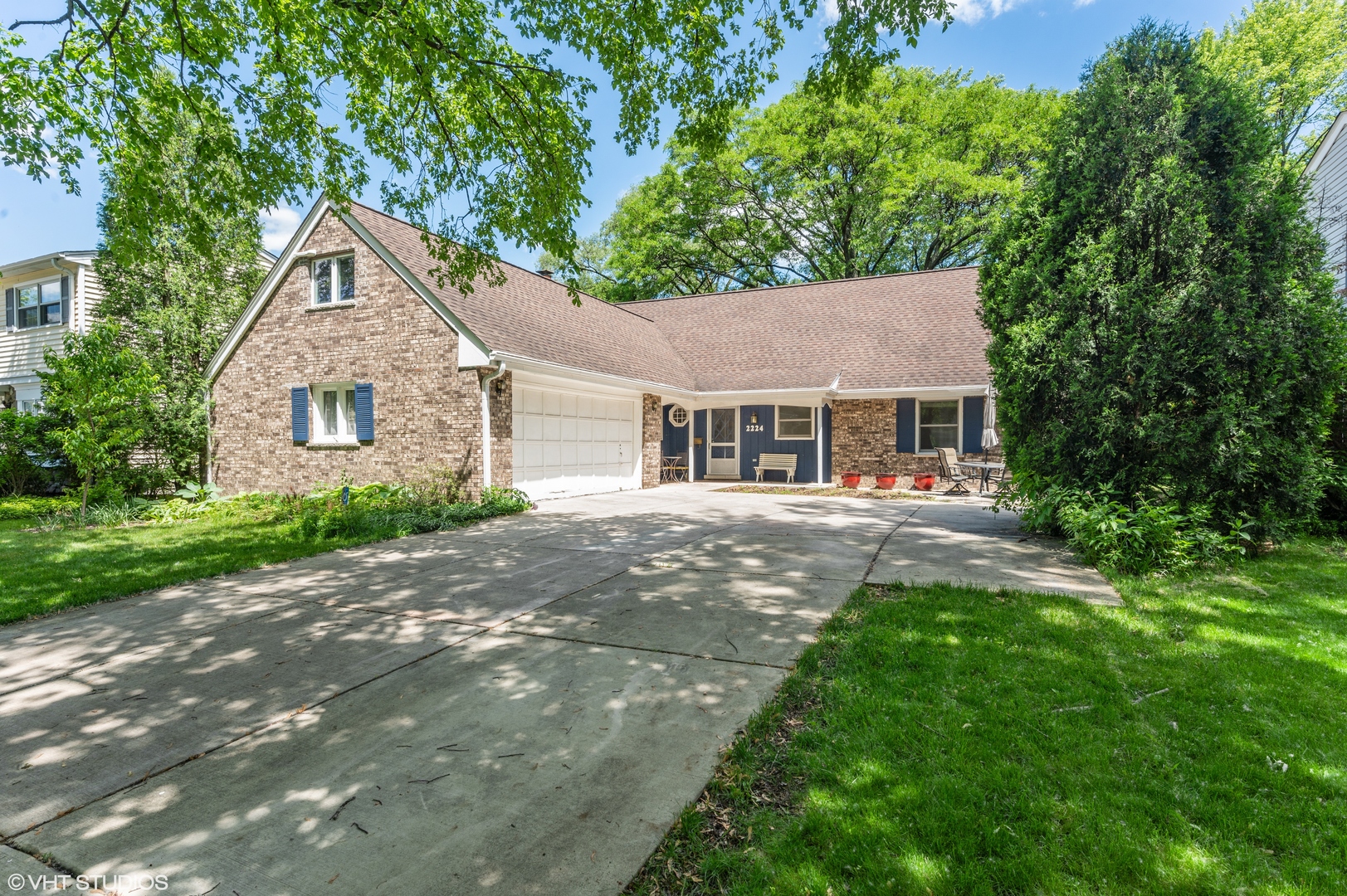 a front view of a house with yard and green space