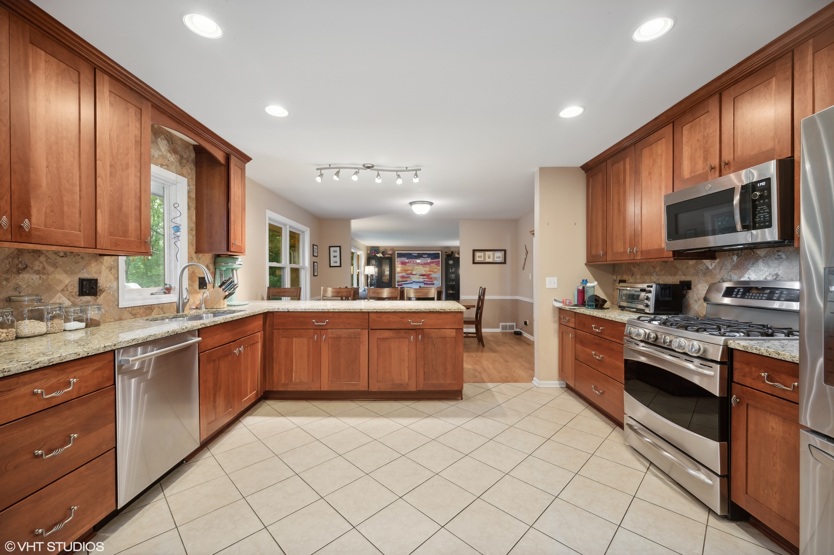 2224 Maple Avenue Northbrook, IL 60062 - Photo 5 of 25 a large kitchen with stainless steel appliances granite countertop a large stove a sink dishwasher and a microwave oven on the blue kitchen countertops