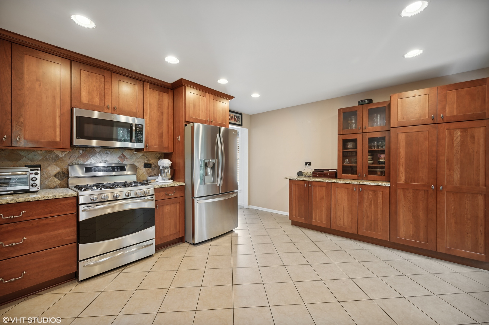 2224 Maple Avenue Northbrook, IL 60062 - Photo 7 of 25 a kitchen with stainless steel appliances granite countertop a refrigerator and a stove top oven