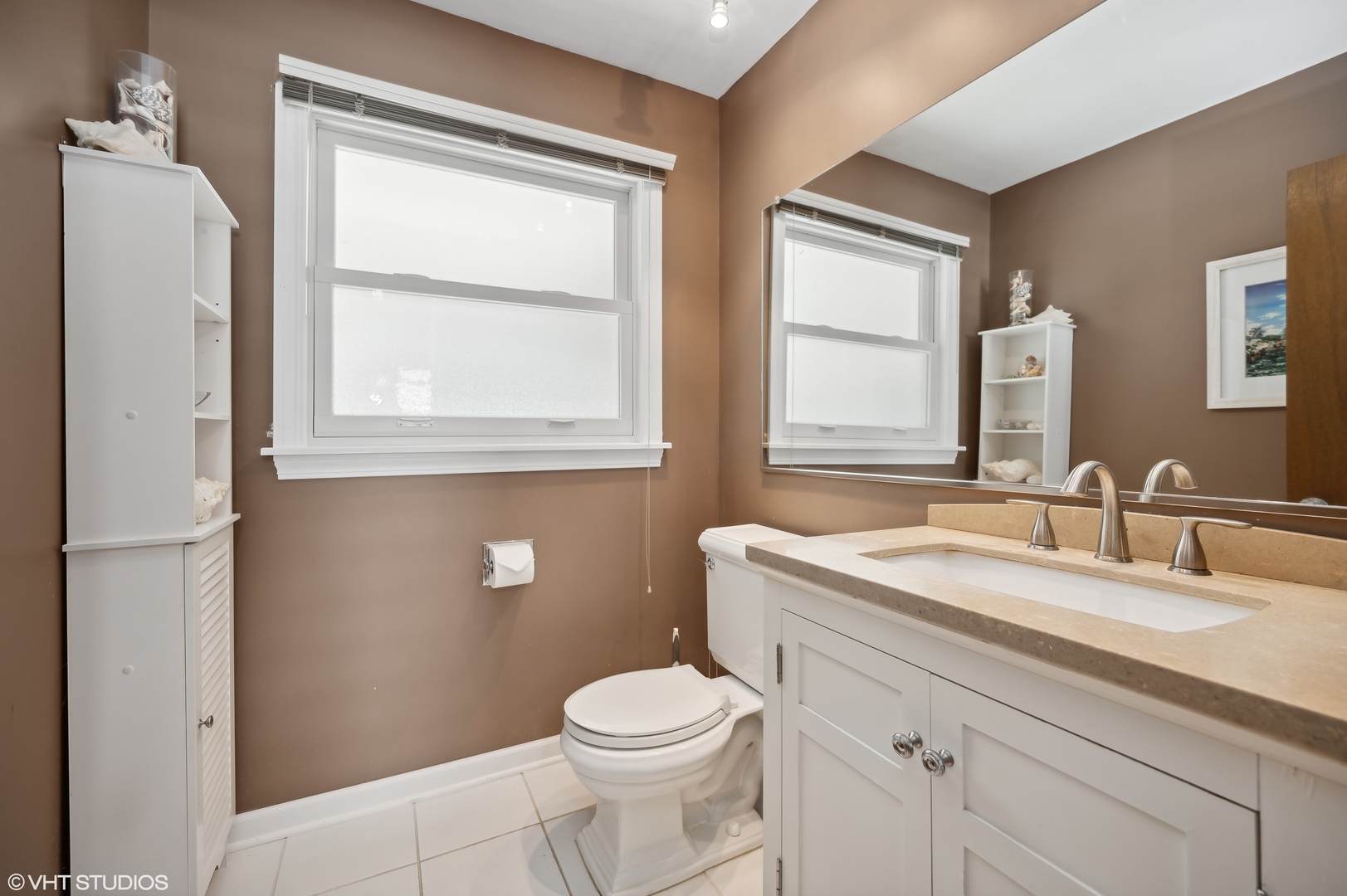 2224 Maple Avenue Northbrook, IL 60062 - Photo 9 of 25 a bathroom with a granite countertop toilet a sink a mirror and a window