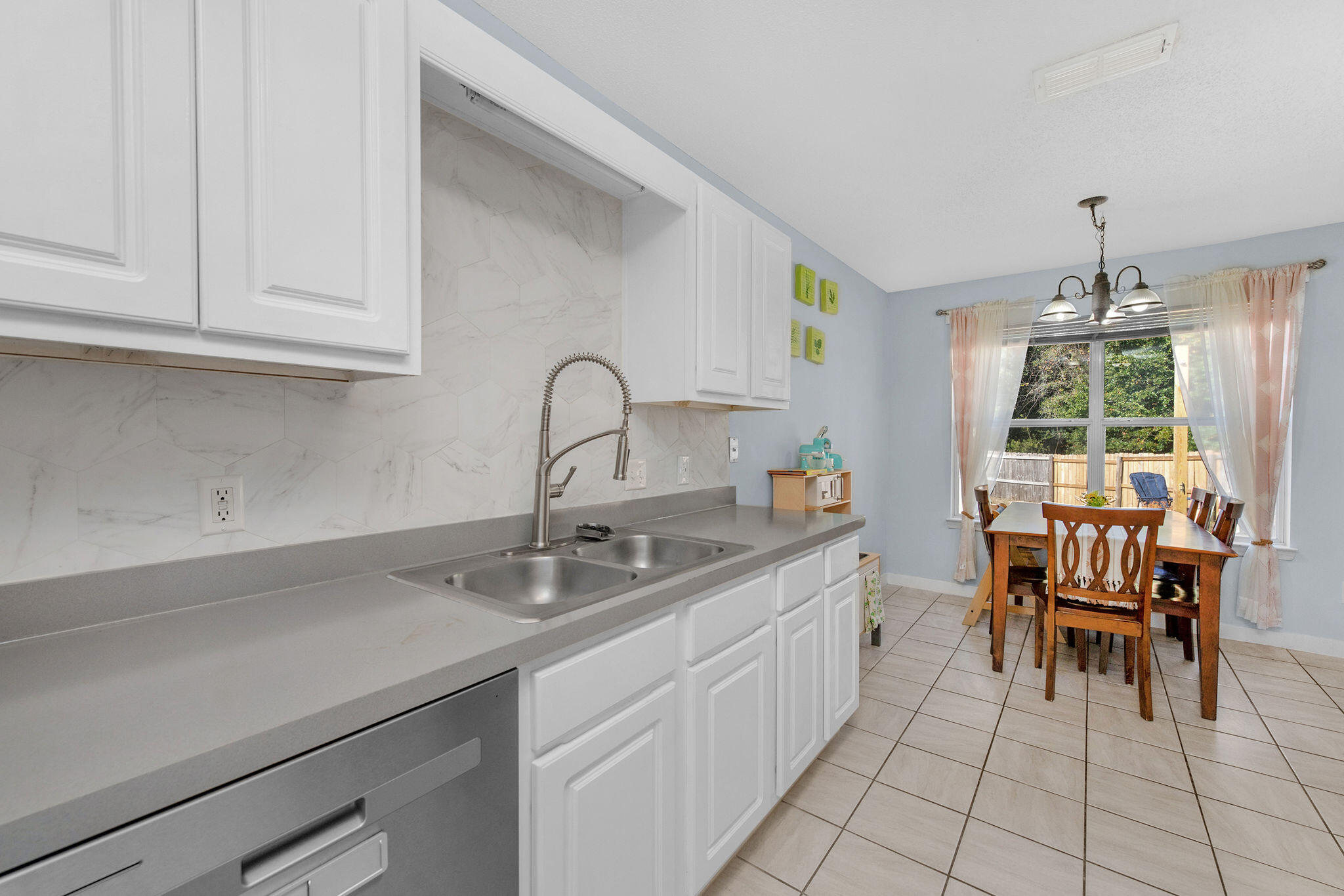 404 Bobby Drive Crestview, FL 32536 - Photo 9 of 30 a kitchen with a sink and cabinets
