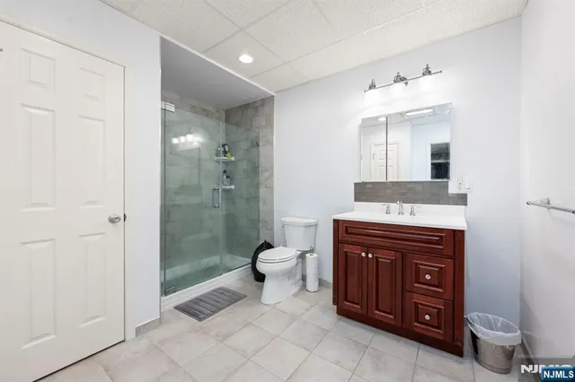 a spacious bathroom with a granite countertop sink toilet and shower