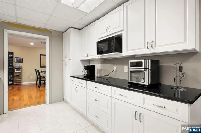 a kitchen with stainless steel appliances granite countertop a sink and a microwave