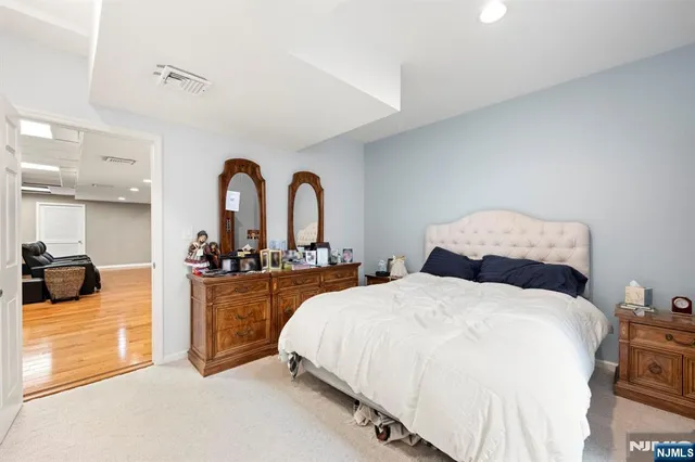 a bed room with two beds and a large mirror