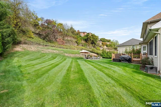 a view of a white house with a yard and garage