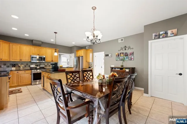 a view of a dining room with furniture and chandelier