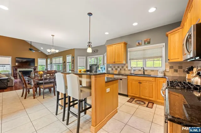 a view of a kitchen with kitchen island granite countertop lots of counter top space
