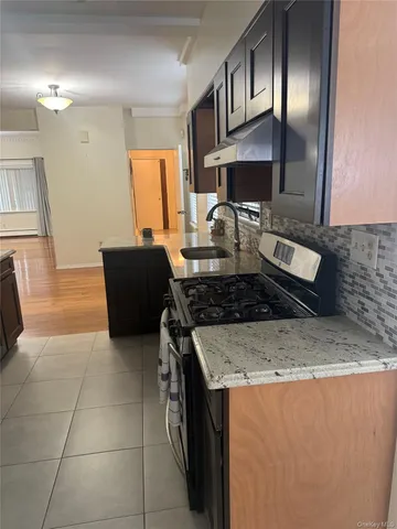 a kitchen with stainless steel appliances granite countertop a sink stove and cabinets