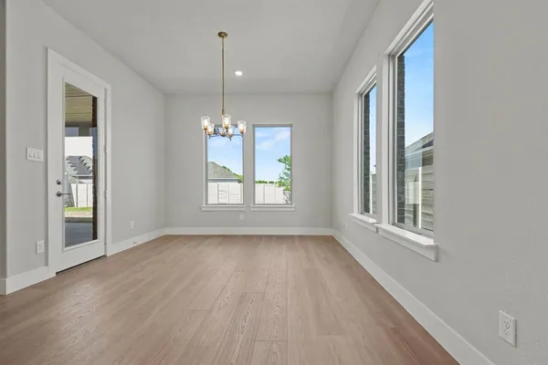 a spacious bedroom with two beds and a chandelier