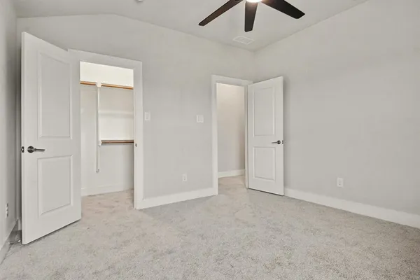 an empty room with windows and closet