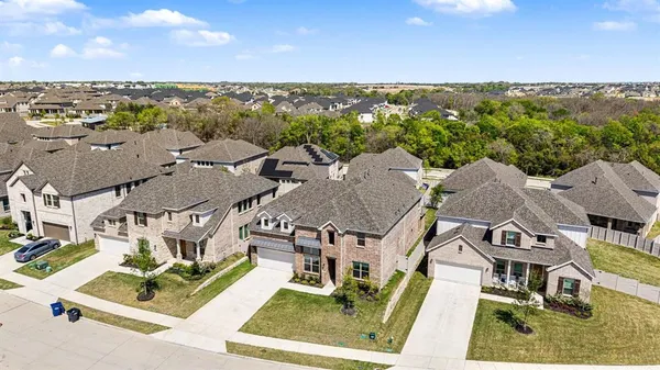 an aerial view of multiple houses with a city view