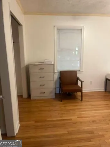 a bed sitting in a bedroom next to a window