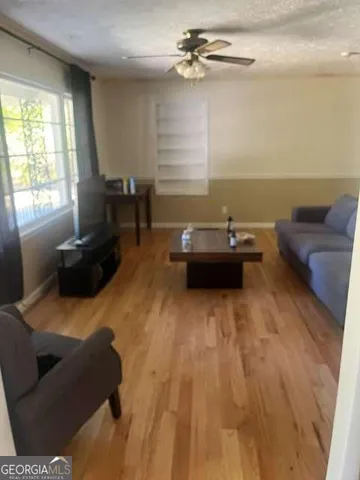 a view of backyard with wooden fence