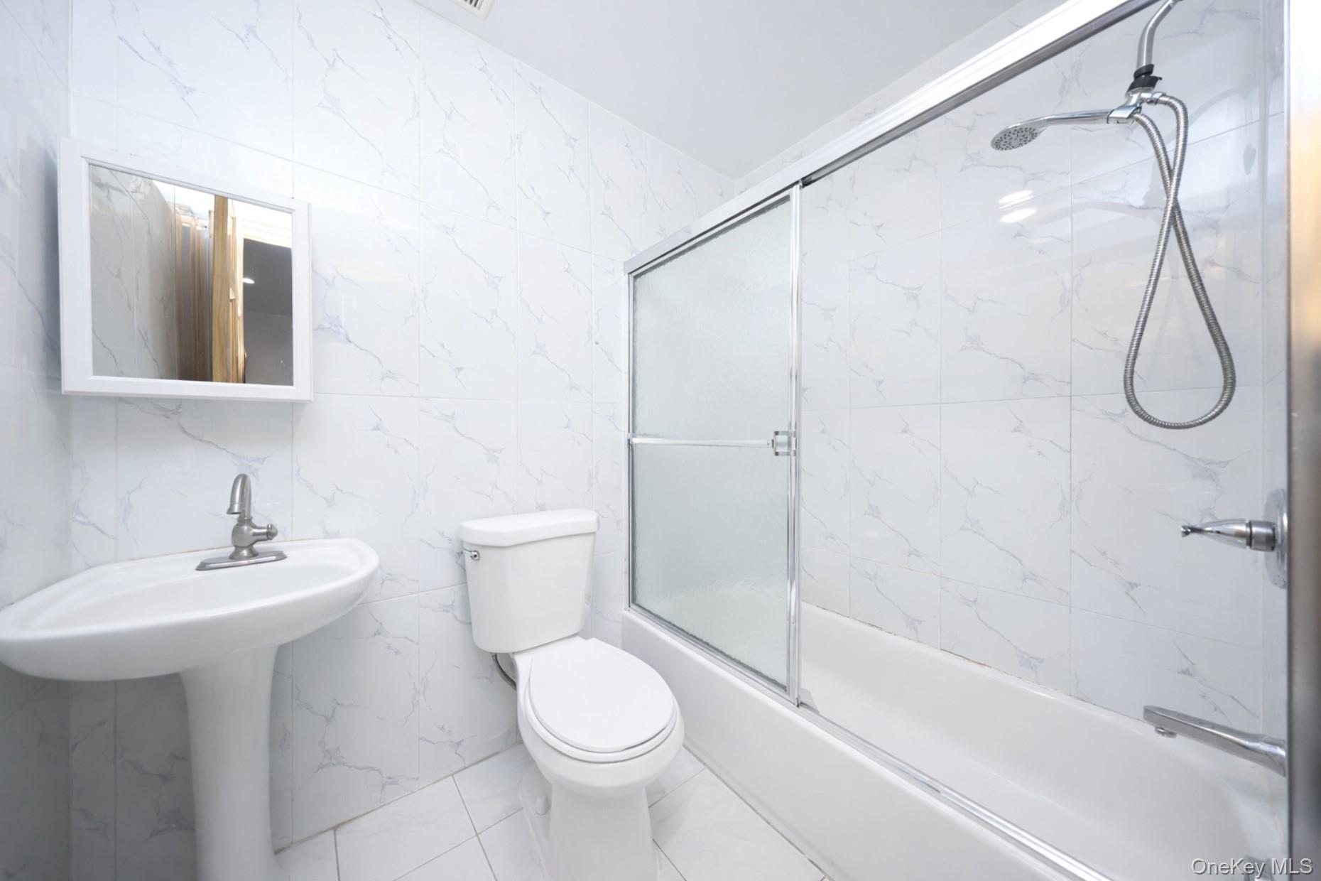 48-01 216th Street Queens, NY 11364 - Photo 12 of 14 a bathroom with a sink toilet and shower