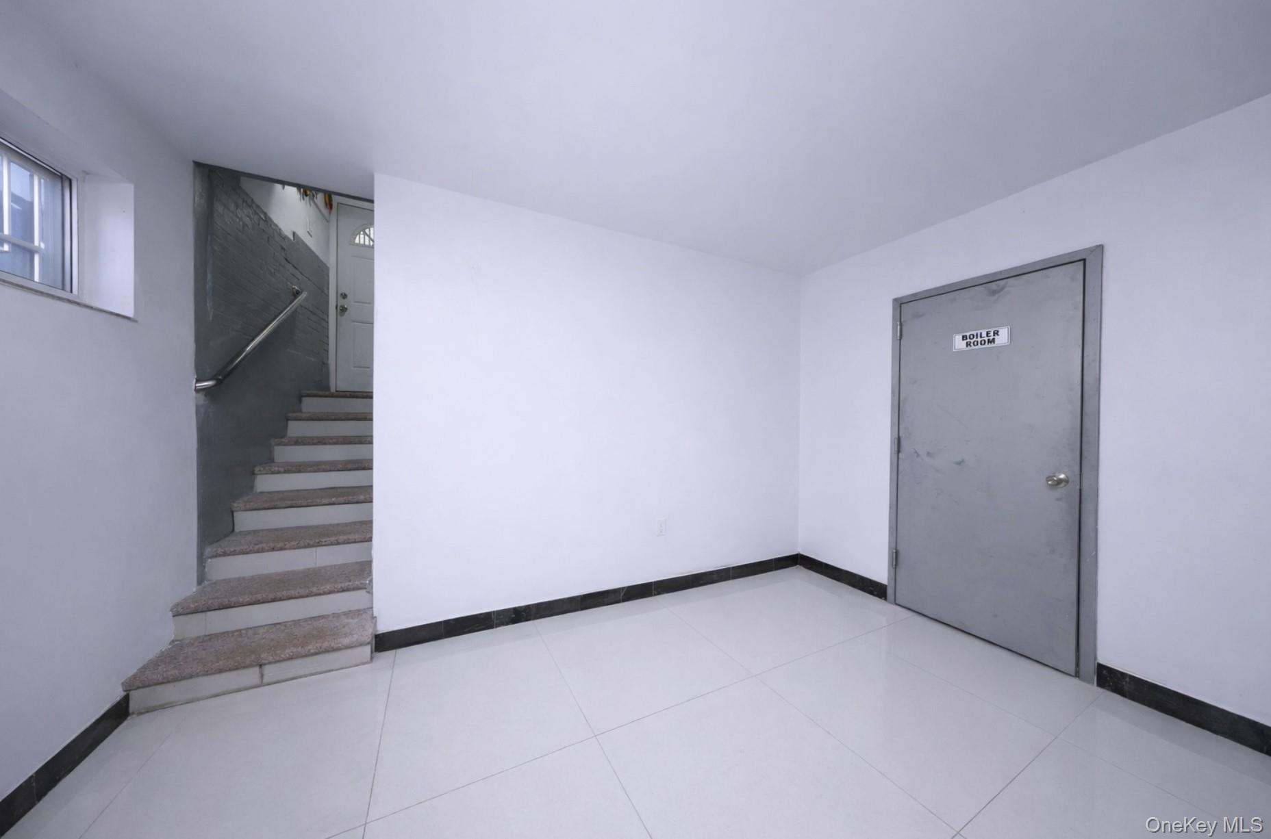 48-01 216th Street Queens, NY 11364 - Photo 13 of 14 a view of an empty room with stairs