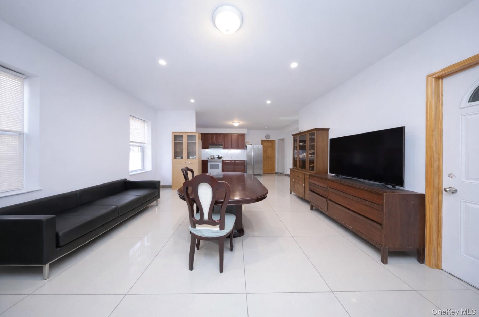 48-01 216th Street Queens, NY 11364 - Photo 8 of 14 a living room with furniture and a flat screen tv