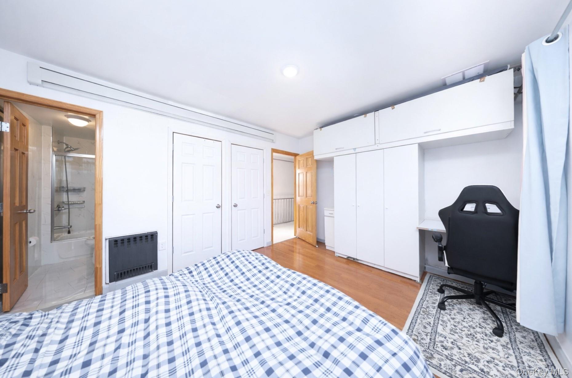 48-01 216th Street Queens, NY 11364 - Photo 9 of 14 a bedroom with a bed and wooden floor