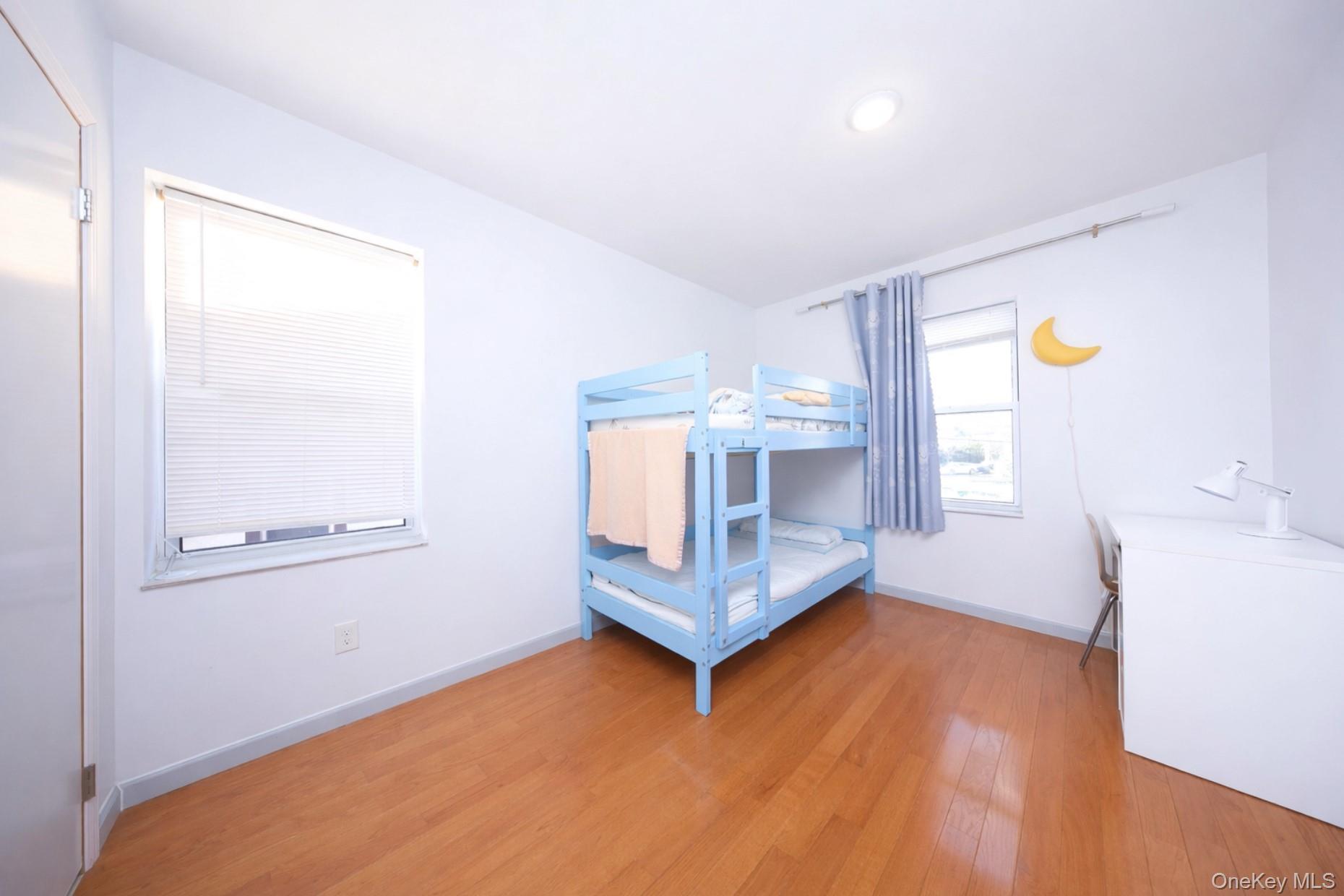 48-01 216th Street Queens, NY 11364 - Photo 10 of 14 a view of a room with wooden floor and window