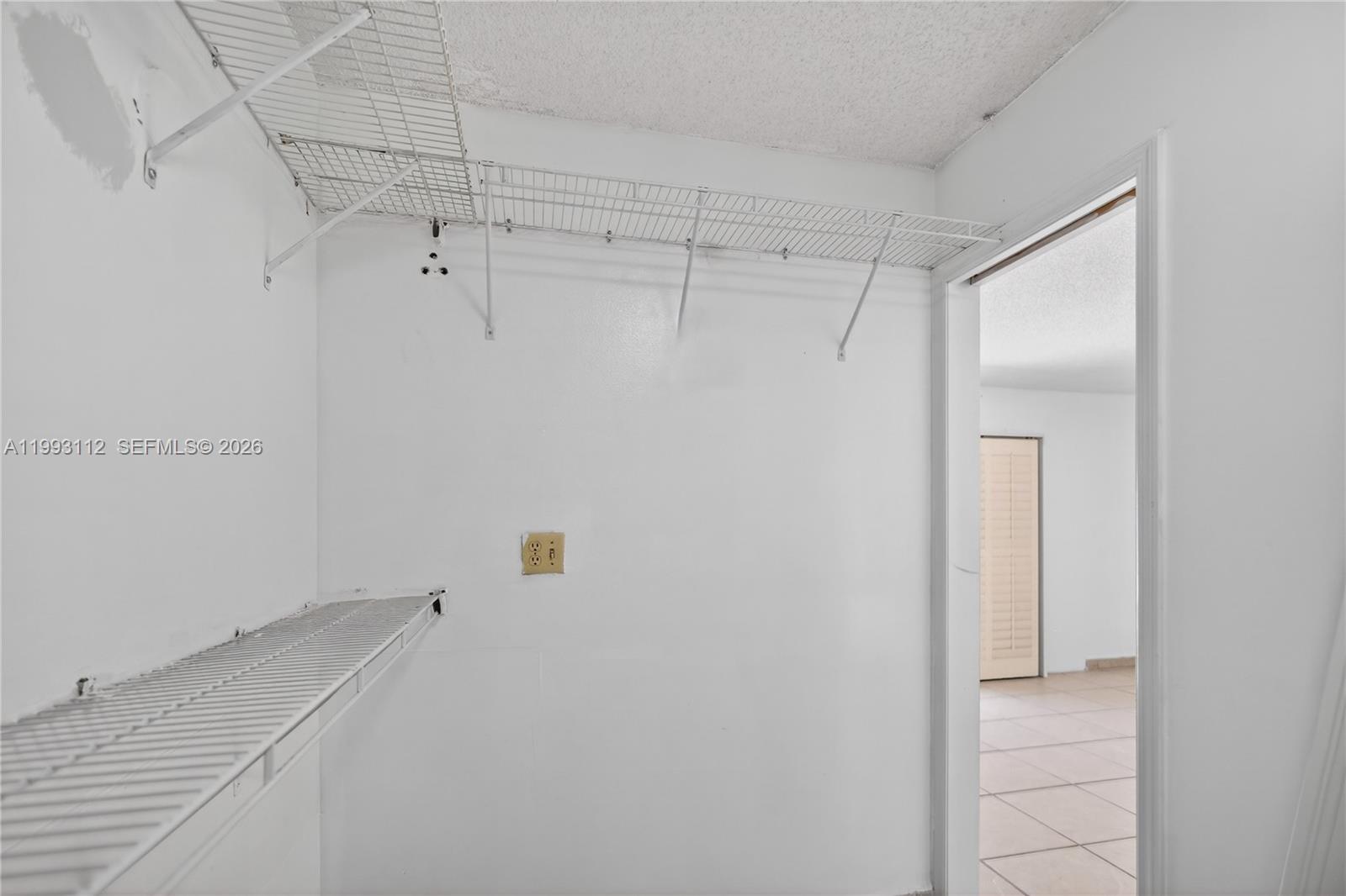 13471 Southwest 99th Terrace Miami, FL 33186 - Photo 25 of 44 a view of a room with racks on the wall