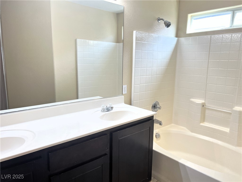 9535 Leaping Lizard Street Las Vegas, NV 89178 - Photo 10 of 37 Primary Bathroom with double sink and washtub / shower combination